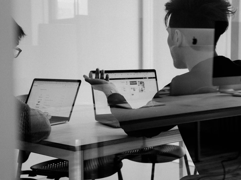 Enterprise software developers working on IEMS platform dashboard for manufacturing client.